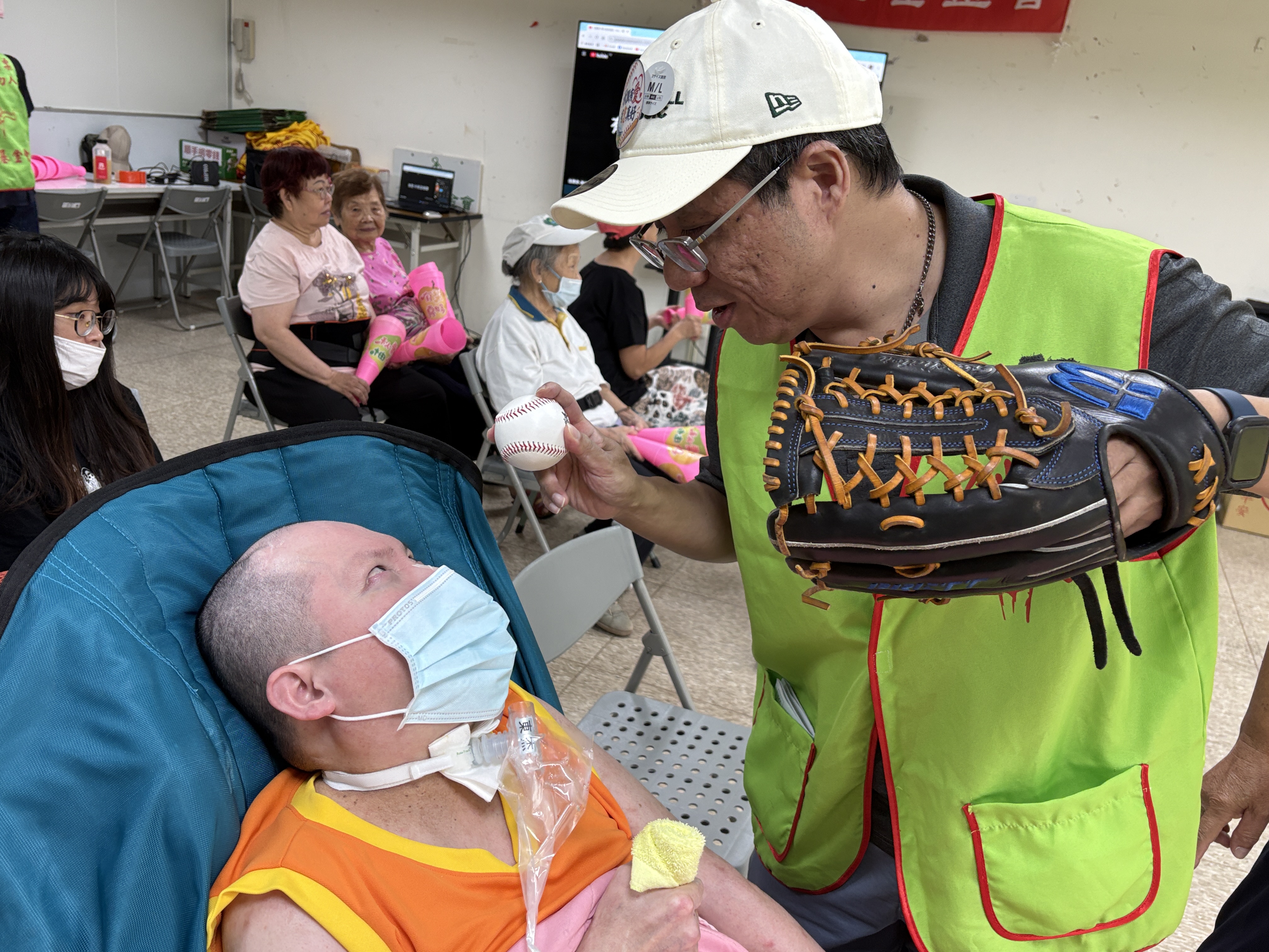 創世台中院長陳韋龍拿著棒球與喜愛棒球的院民阿杰互動，以行動傳遞陪伴與關懷。（圖／創世基金會台中分院提供）