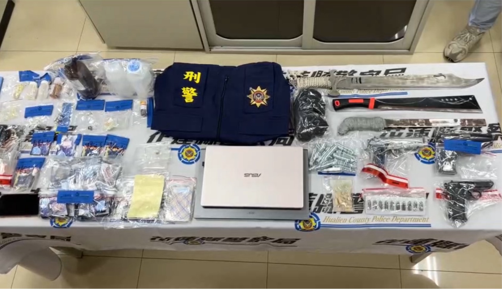 ▲警方日前展開掃黑行動，一舉攻堅11處據點，查獲14人到案，起出改造手槍、子彈、毒品、仿冒刑警背心等大量證物。（翻攝畫面）
