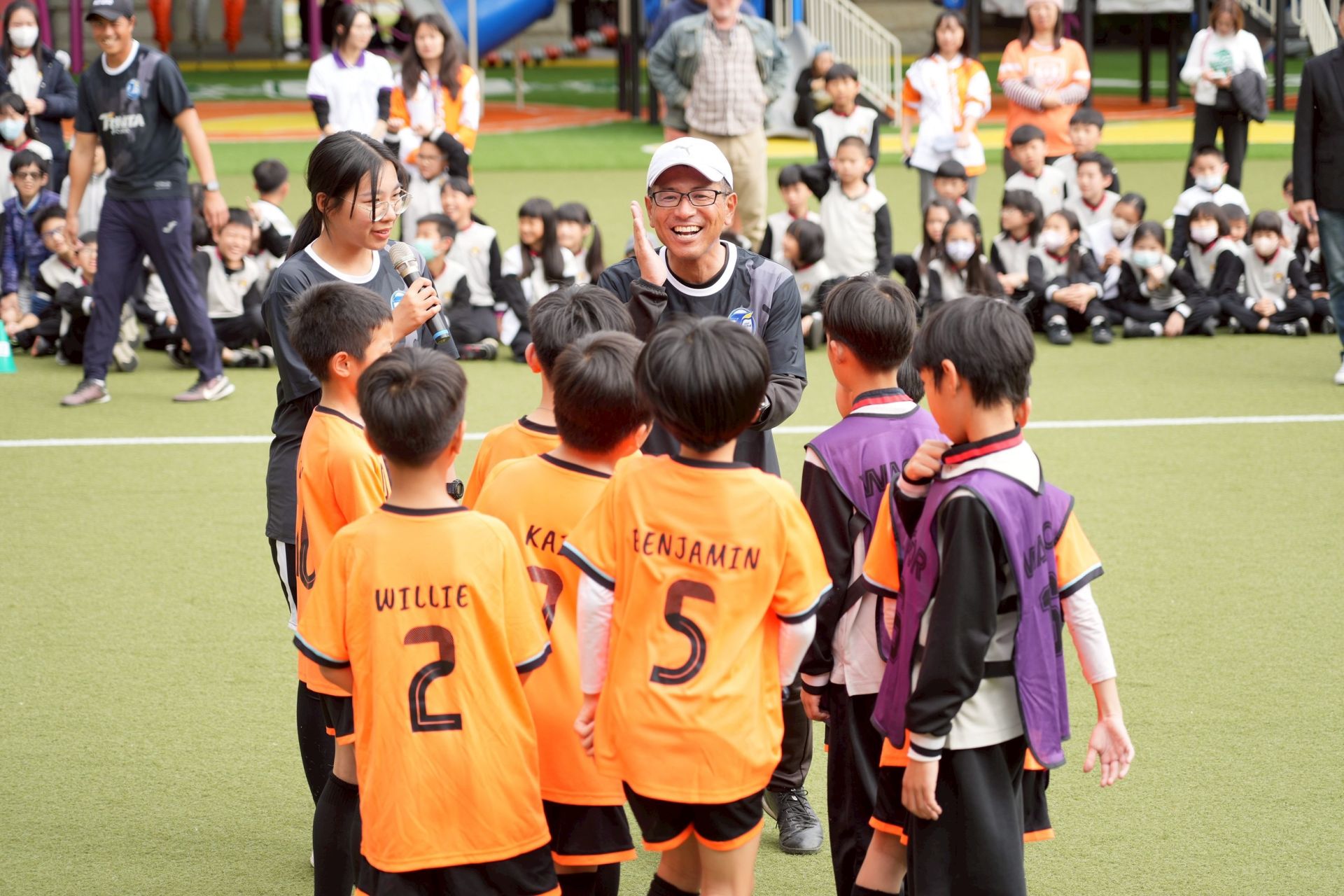 籍教練片山幹彥親自指導葳格小學生踢球，透過互動教學激發學習興趣。