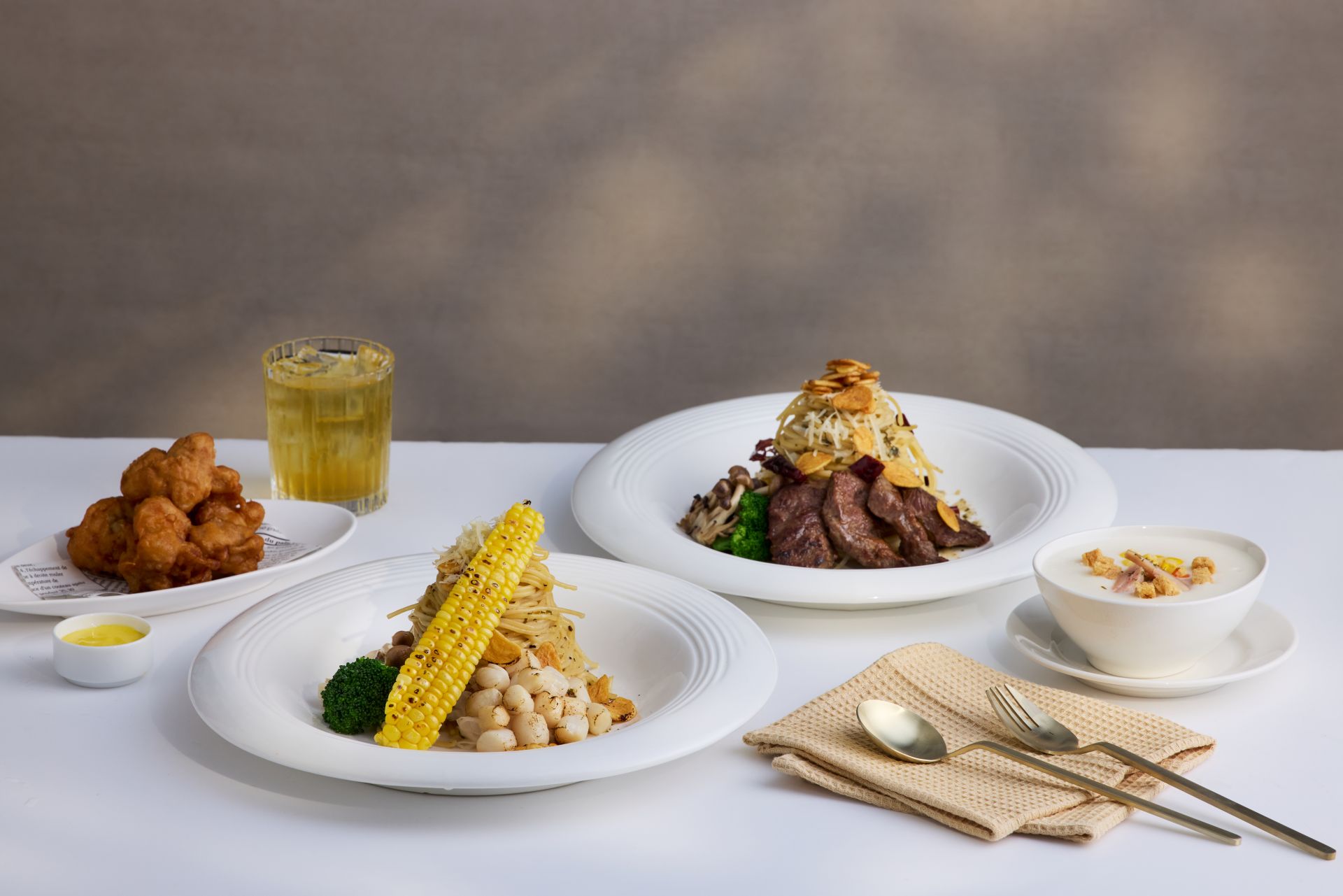 亮點新品「蒜辣嫩煎板腱牛佐香酥嫩雞義大利麵」，透過「雙肉主食」的豪華配置，滿足肉食控對飽足感的極致追求。